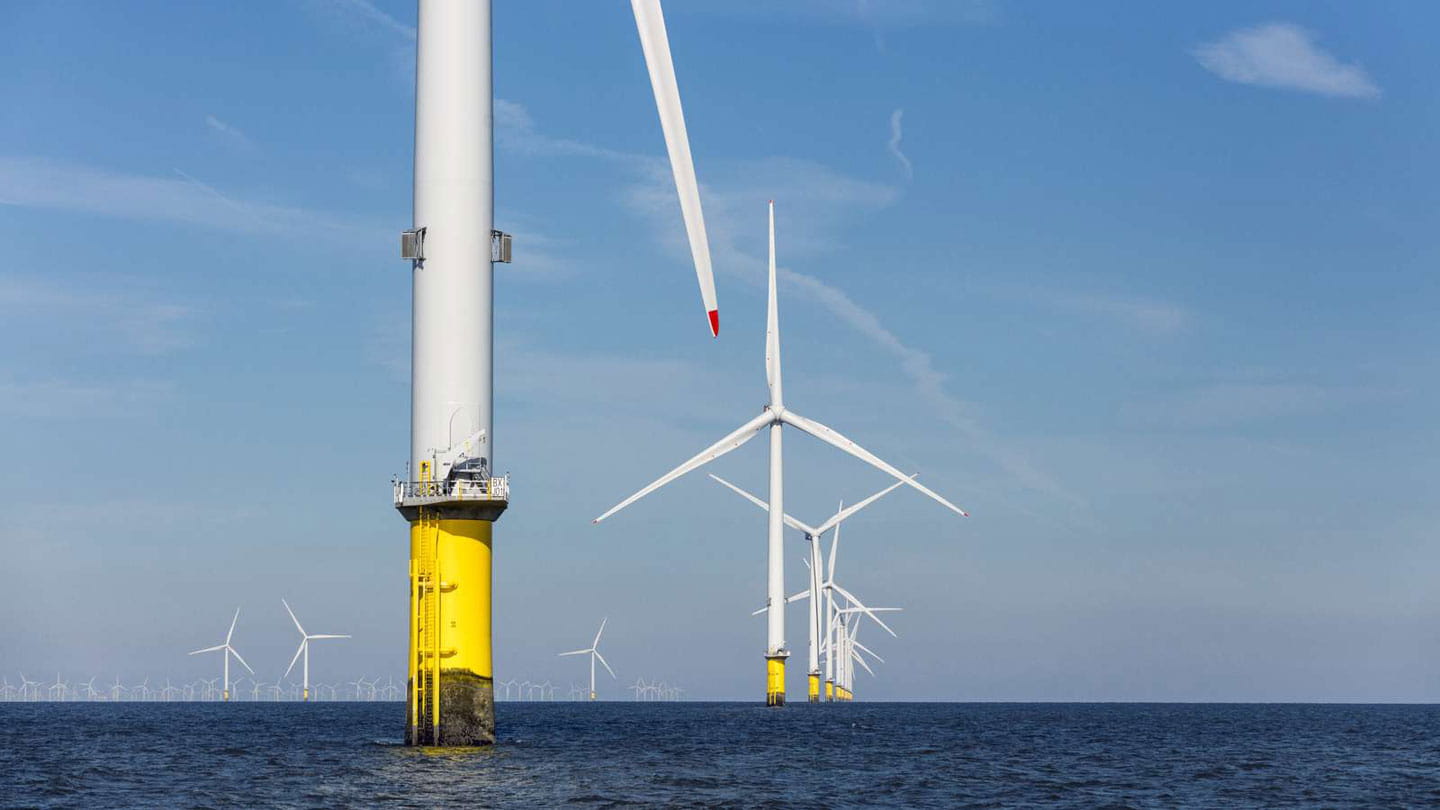 A low-angle shot from an offshore wind farm.