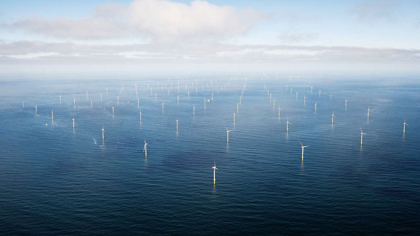 Distant view of an offshore wind farm.