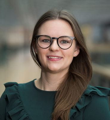 &#216;rsted Senior Invester Relations Officer Sabine Lohse wearing a green shirt and glasses.
