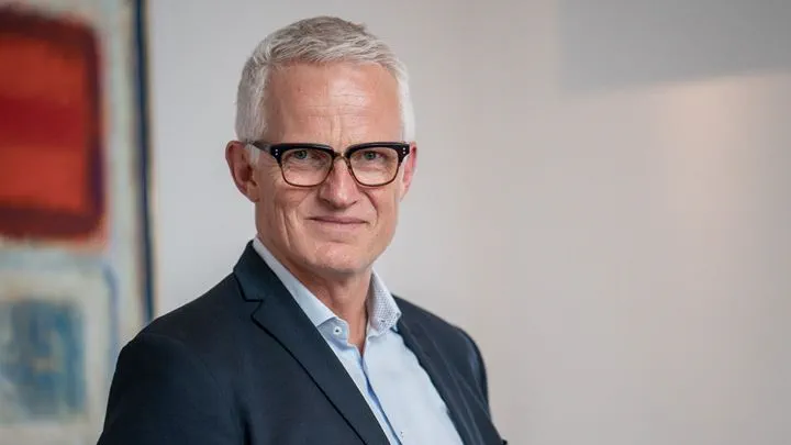 Mads Nipper, CEO of Ørsted, wearing a suit and glasses while smiling.