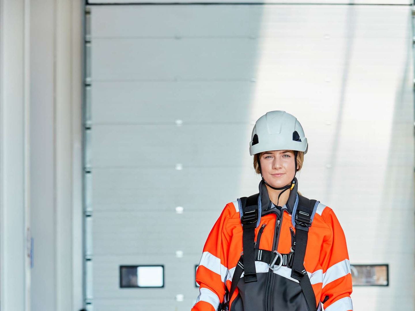 Woman in high-visibility clothing and hard hat.