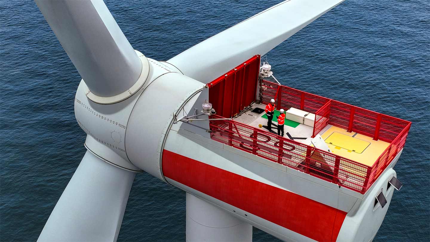 Employees on top of a wind turbine
