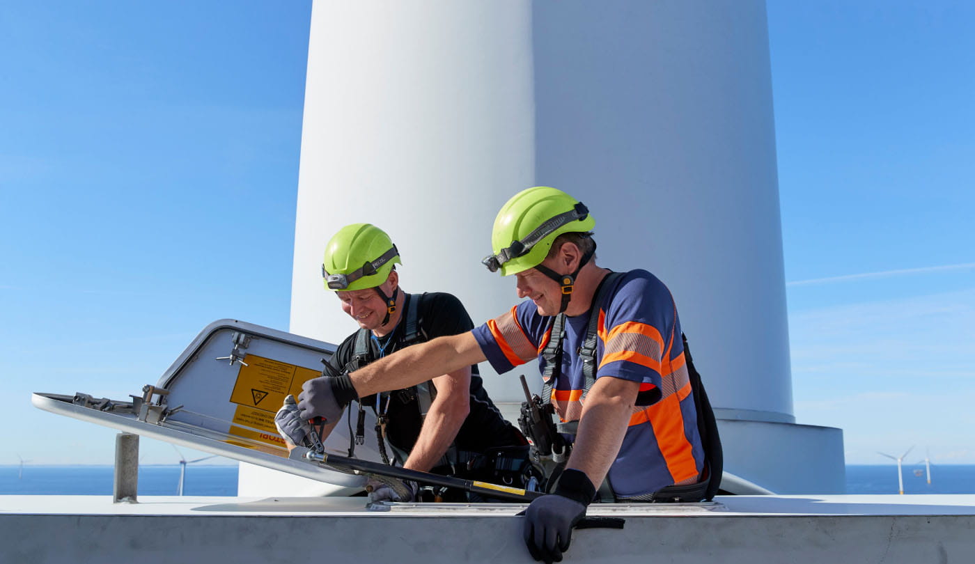 two engineers working on an offshore wind turbine