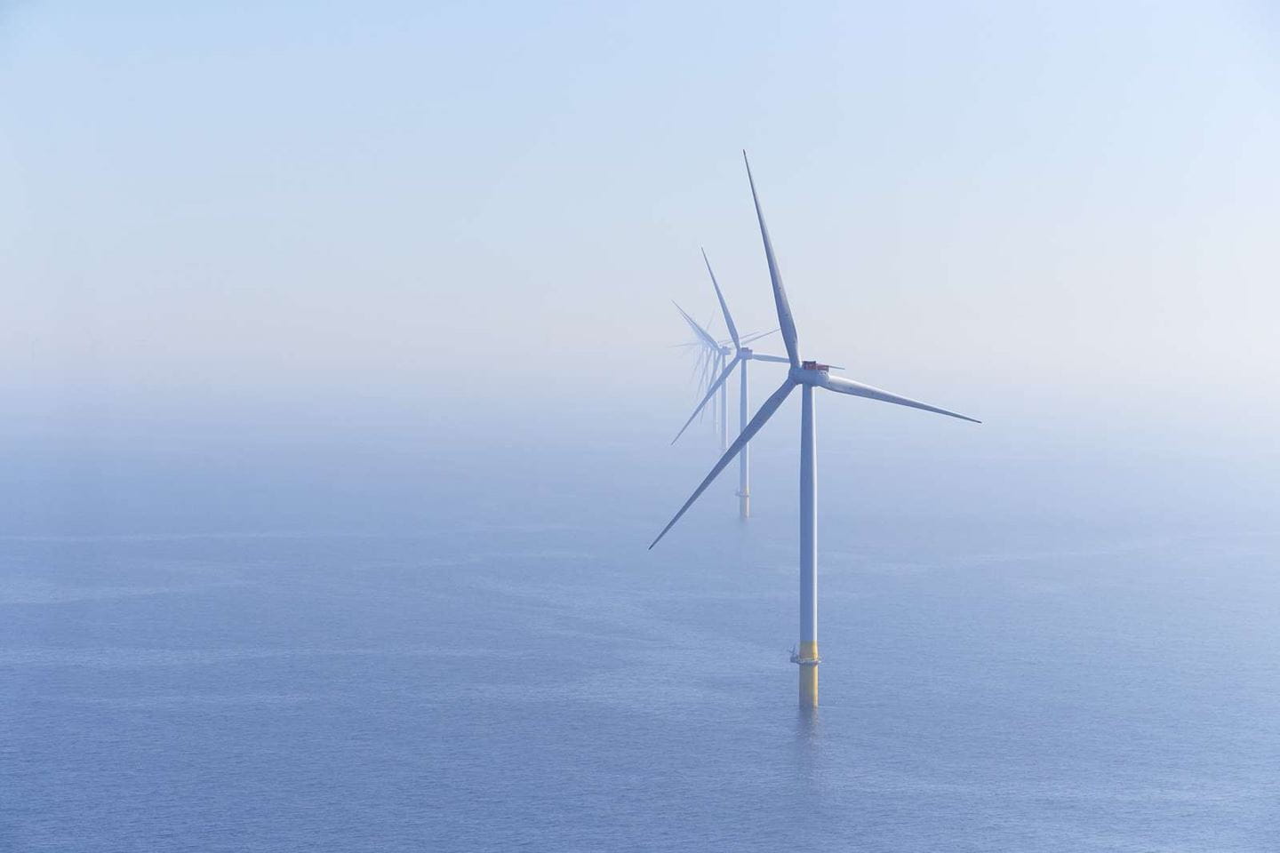 Image of an offshore wind turbine with further  turbines in the distance