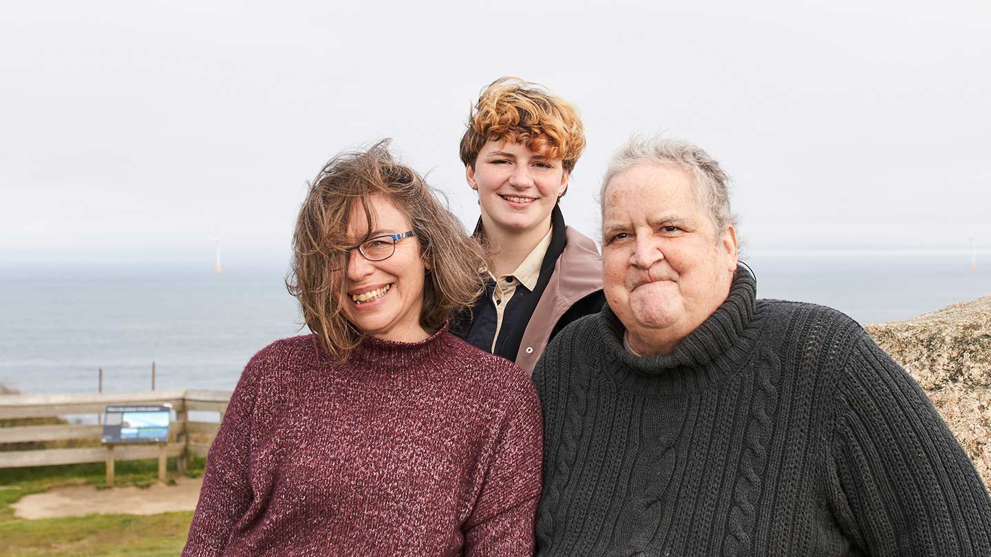 Local resident Bryan Wilson, former manager of the Block Island Wind Farm, stands with his family at an island viewpoint.