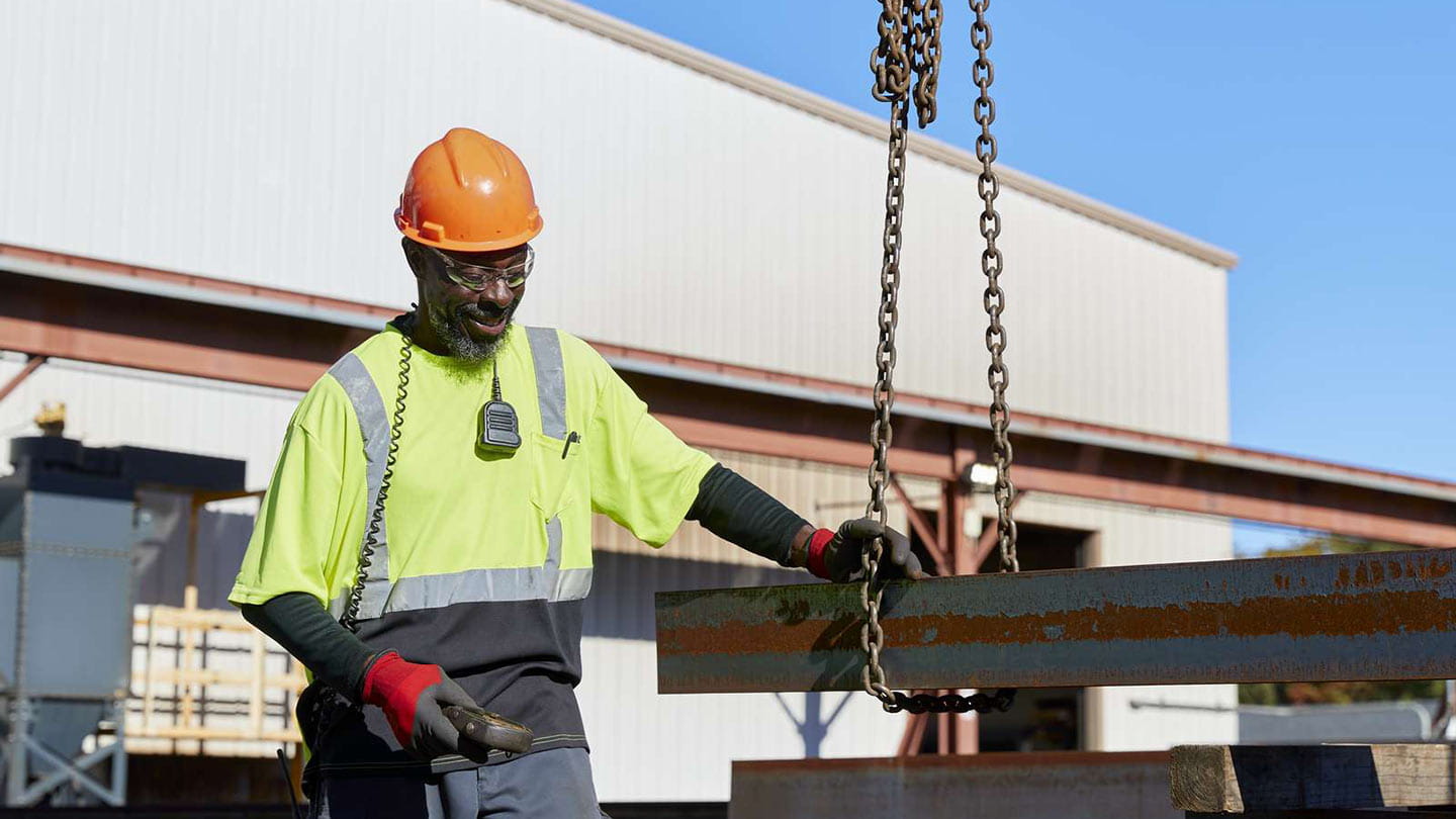 A Black union worker standing by iron beams for a clean energy project, part of Ørsted's new American workforce.