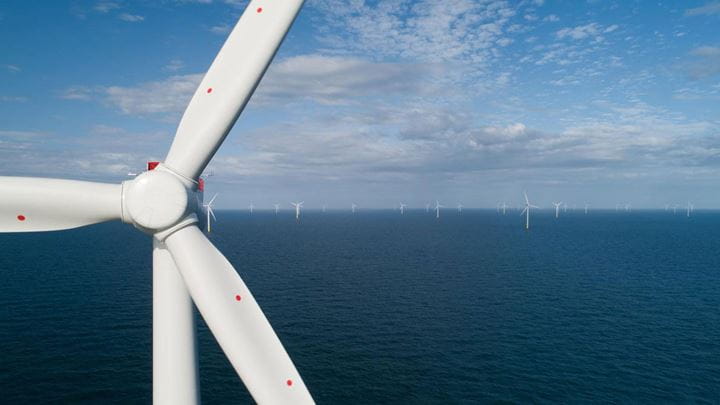 An offshore wind turbine standing in the ocean, part of Ørsted's rapidly growing offshore wind portfolio in America.