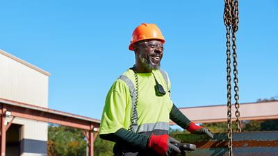 An African-American man working on a construction site, building infrastructure for America&#39;s clean energy industry.