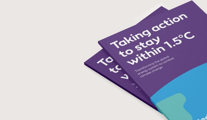 Two booklets entitled 'taking action to stay within 1.5°C' lie on top of each other.